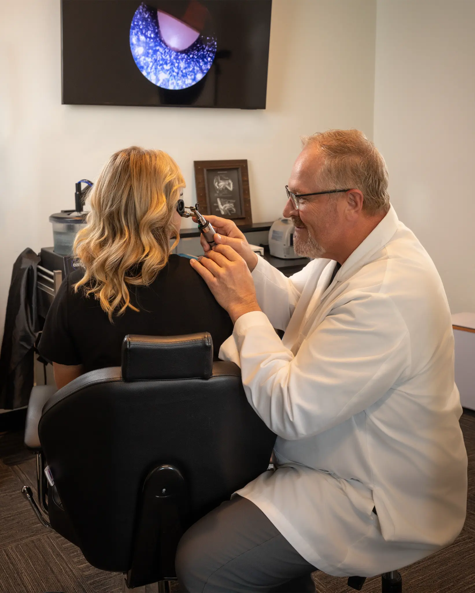Boise Hears clinician completing a close-up hearing assessment with a patient